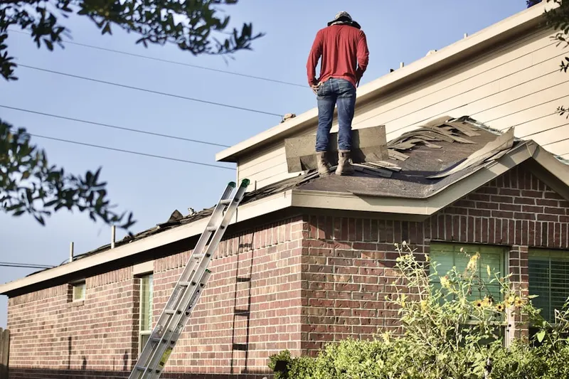 Professional roofer working on a residential roof in Brockway Vista